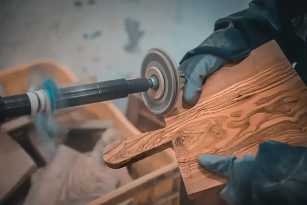 Artisan shaping olive wood in the Sfax workshop
